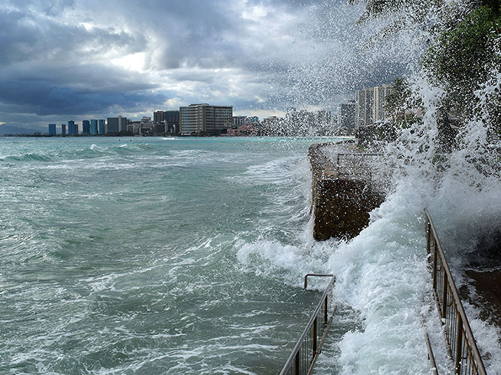 The King Tide crashes into the sidewalk in Waikiki