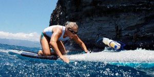 Kanessa paddles on a board