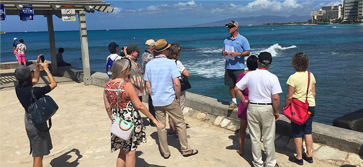 A guide shows tourists around Waikiki