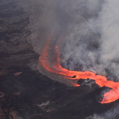 Lava flows from the volcano and steam comes off