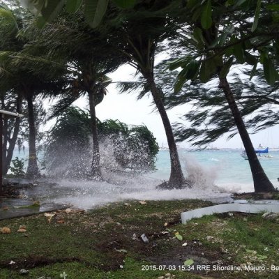 Waves and a tree crash into shore during a storm in Majuro