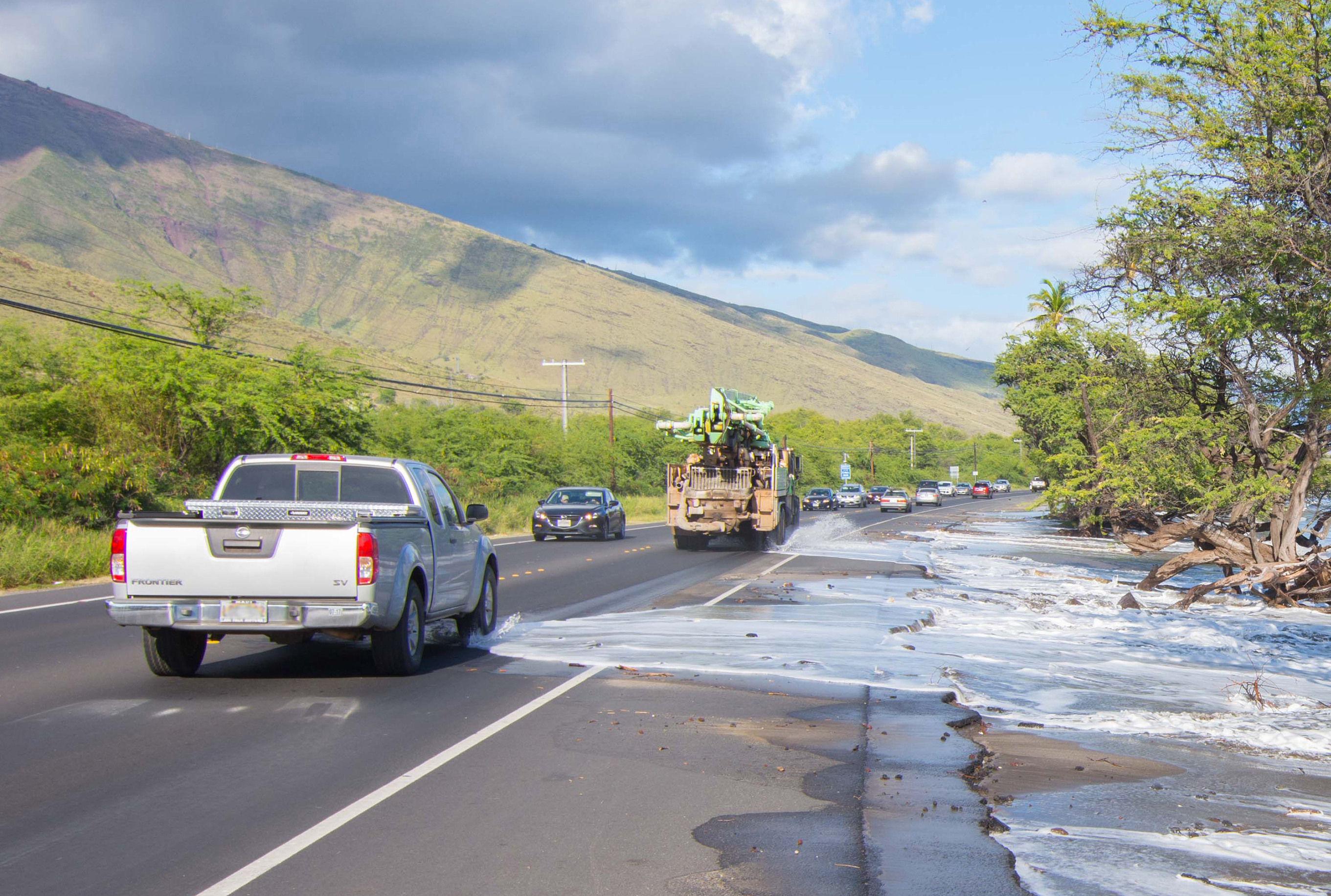 High tide washes over a road