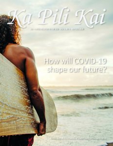 Cover of Ka Pili Kai, Dr. Kapono stands facing the surf, surfboard under his arm.