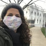 Beth Lenz (masked) poses for a selfie on a path to the White House