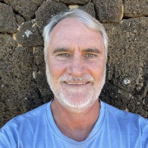 Headshot of Simon Ellis against a rock wall