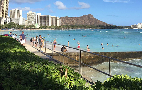 Tourists enjoying Waikiki Beach on a sunny day