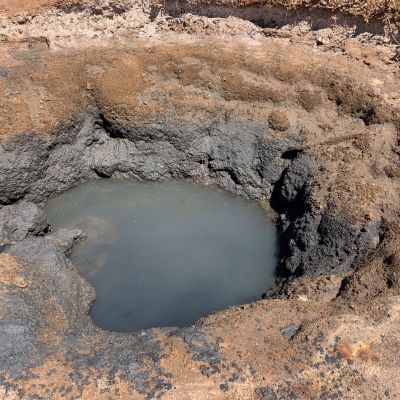 Different layers of clay are visible after a well has drained